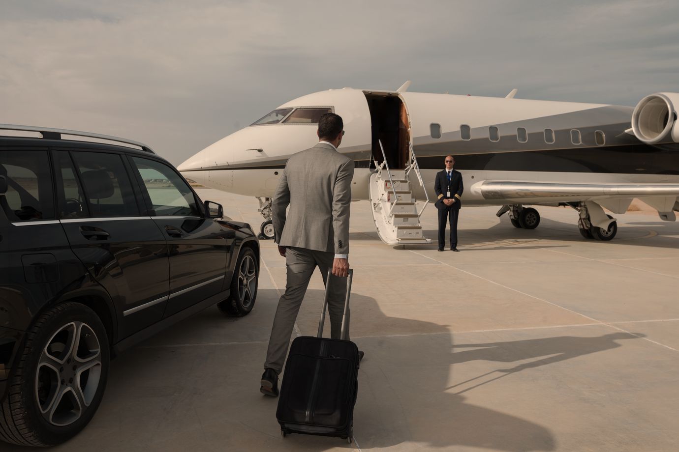 Guest walking from the car to a private jet, crew waiting at the stairs